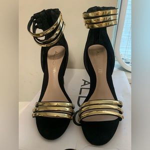 Also black and gold open toe shoes.